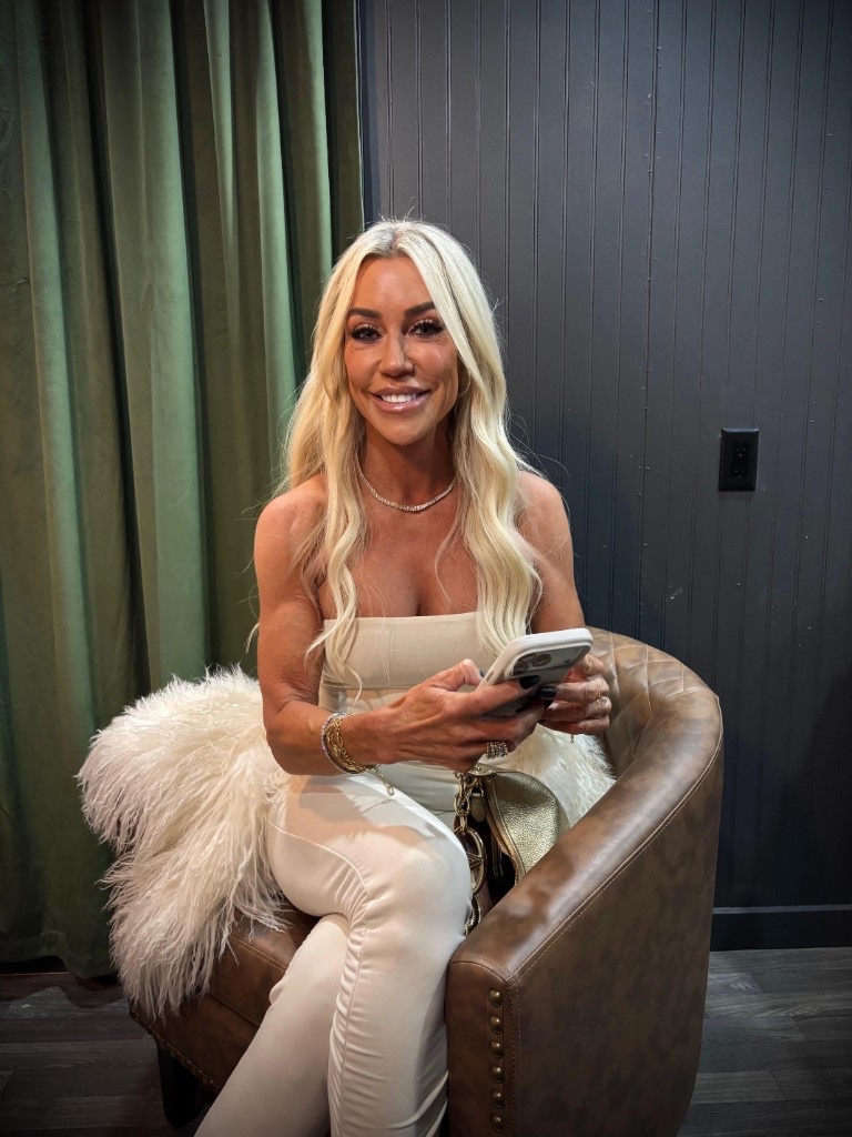Karen Baldwin, founder of Baldwin Armor, seated in a leather armchair.