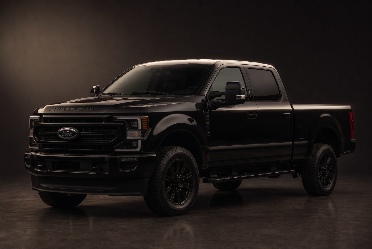 Black heavy duty crew cab pickup truck, front three quarter view in a dark studio
